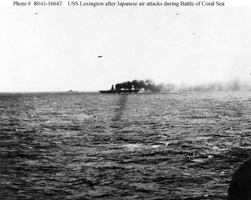 USS "Lexington" (CV-2) afire and down at the bow, but still steaming and operating aircraft, 
shortly after she was hit by Japanese torpedoes and bombs during the Battle of the Coral Sea.