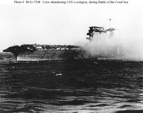 A destroyer alongside USS "Lexington" (CV-2) as the carrier is abandoned during the afternoon of 8 May 1942
