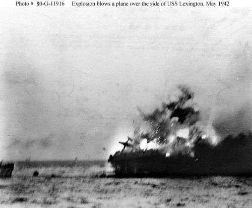 A heavy explosion on board USS "Lexington" (CV-2) blows an aircraft over her side, 8 May 1942